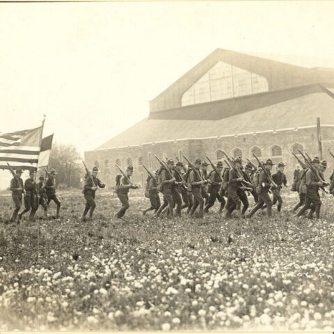 Barton Cadets running outside with rifles.